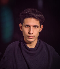 Closeup of young man, dark hair and green eyes