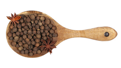 Allspice, pimento spice, Jamaican pepper pile and anise stars in wooden spoon isolated on white, top view