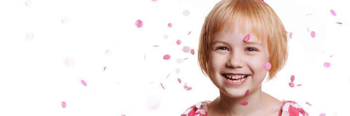 Banner portrait of a cute baby girl in a birthday dress. Cheerful child in a cap isolate on a white...