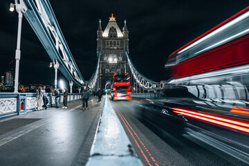 Fototapeta na wymiar London Bridge over Thames in London by night with light trails long exposure
