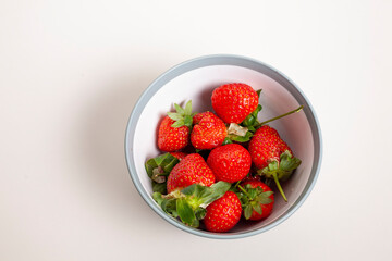 red strawberry with water in bowl