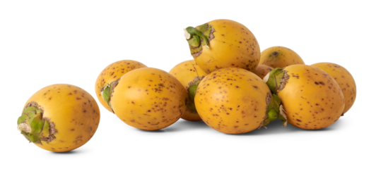 pile of fresh and yellow husk areca nuts, fruit of the areca palm, areca nut palm or betel palm, scattered tropical and commercially important fruits isolated