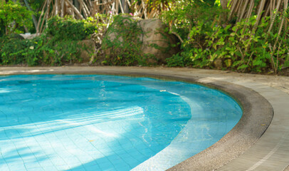 Beautiful luxury swimming pool with palm trees. Thai, Phuket. Vacation concept.