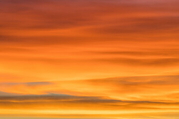 Orange sky and beautiful cloudscape on fire during sunrise useable as background or banner