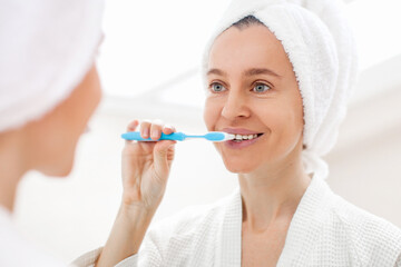 Happy Lady Brushing Teeth With Toothbrush Standing In Bathroom Indoor