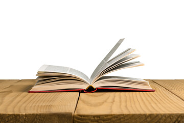An open book lies on a wooden table