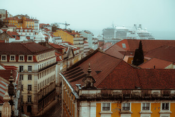 A capture of the charming beauty of the historic Portuguese architecture from the rooftops. And in the background a cruise moored in the Rio Tejo, adding to the picturesque atmosphere of the city