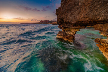 Marine arch in Macari bay at dusk, Sicily	