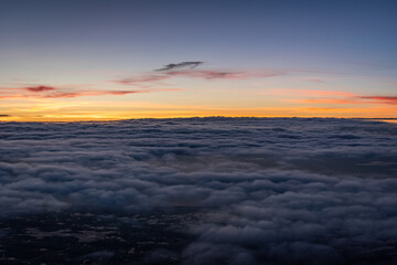 Fototapeta na wymiar Beautiful sunset above the clouds over the city of Amsterdam, the Netherlands