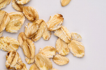 Fototapeta premium Macro photo of oatmeal on a white background,texture,background. Healthy, tasty food, a source of amino acids, minerals.