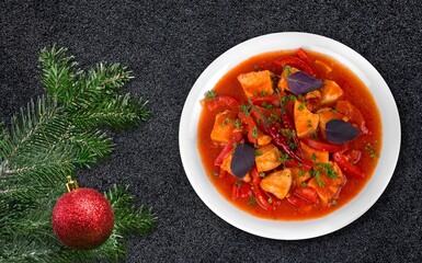 Tasty fresh hot dish with a Christmas branch