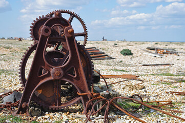 rusting boat winch on beach