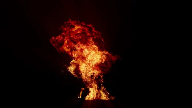 Impressive intense explosion on a black background. Dynamic composition of a detonating bright colorful explosion, shock wave and puffs of smoke filling the space
