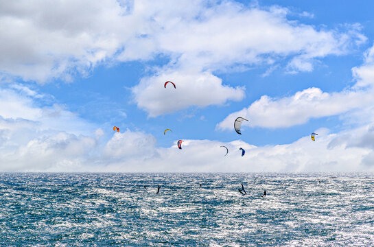People practicing kitesurfing on the beach of Los Ca&ntilde;os de Meja, next to the Trafalgar Lighthouse, Barbate, Cadiz
