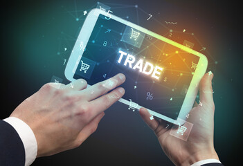 Close-up of a hand holding tablet with shopping inscription