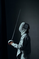 beautiful man fencer with a foil rapier sword