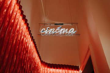 Cinema retro neon light sign before entrance to hall. picture theater