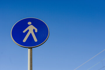 Road car round blue sign. Pedestrian crossing
