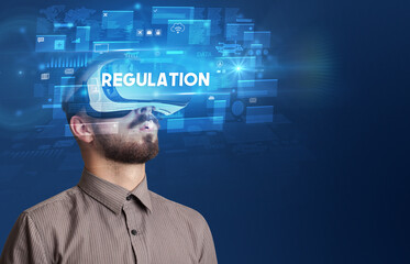 Businessman looking through Virtual Reality glasses