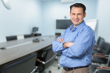 Smiling young business man employer in office