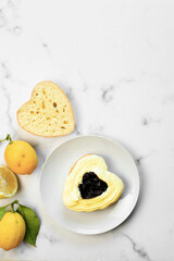 Heart lemon cake in preparation. White background and copy space