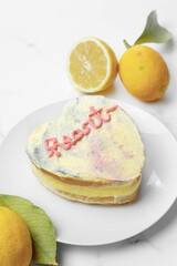 Heart lemon cake in preparation. White background and copy space