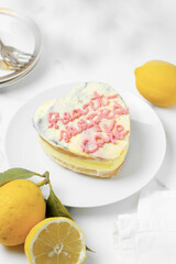 Heart lemon cake in preparation. White background and copy space