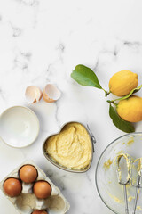 Heart lemon cake in preparation. White background and copy space