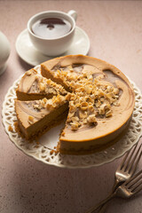 Caramel cheesecake served with cup of tea