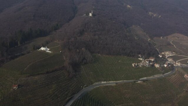 Aerial shot of the Unesco proseco hills, wine mountains framed by the Venetian fog.
Cold and foggy winter.