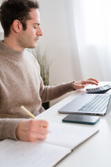 Crop man working on laptop