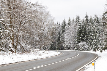 Beautiful view of the road in the winter forest.