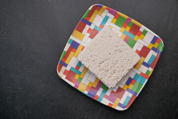  top view of hands tofu on a plate on table 