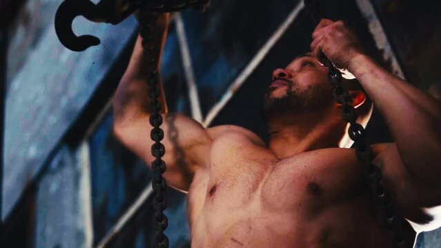 Man working out with ropes at the gym. muscular model working out with ropes