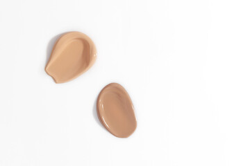 Makeup foundation, beige concealer swatch smudge smear on white background. BB CC cream texture