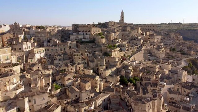Aerial footage of Sassi di Matera in Basilicata, South Italy.Drone view of Sasso Caveoso and Civita districts, old city houses carved in rock caves, bell tower of Cathedral, Unesco heritage from above
