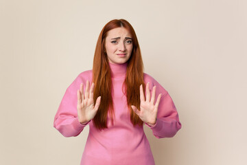 Young red hair woman isolated rejecting someone showing a gesture of disgust.