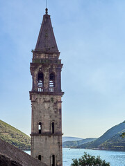 Belfry of St. Nicholas in Perast at sunset  with the bay of Kotor in the background. Montenegro, Europe