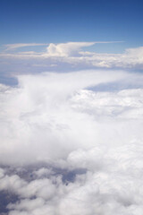 Obraz premium aerial view of three anvil cumulonimbus incus clouds in a blue sky
