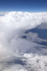 aerial view close up of an anvil cumulonimbus incus cloud in a blue sky 
