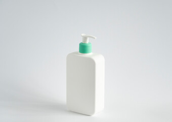 White blank plastic bottle with dispenser pump for gel, liquid soap, lotion, cream, shampoo on white background. Cosmetics.