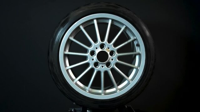 old car wheels titanium rims long exposure video on dark background spinning motion simulation