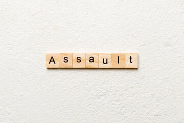 assault word written on wood block. assault text on table, concept