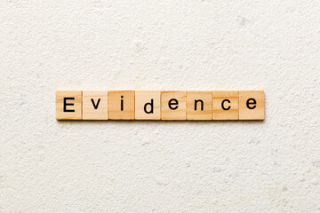evidence word written on wood block. evidence text on table, concept