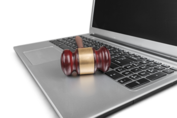 Classic brown justice wooden hammer on laptop