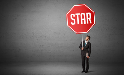 Young business person holding road sign