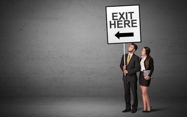 business person holding a traffic sign