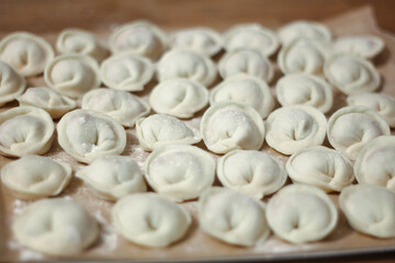 Fresh homemade dumplings handmade lie on the table