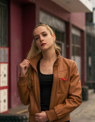  blonde model walking down the street with jacket