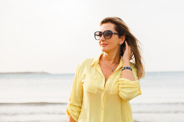 Portrait of a woman on the beach, ocean, unity with nature, healthy lifestyle